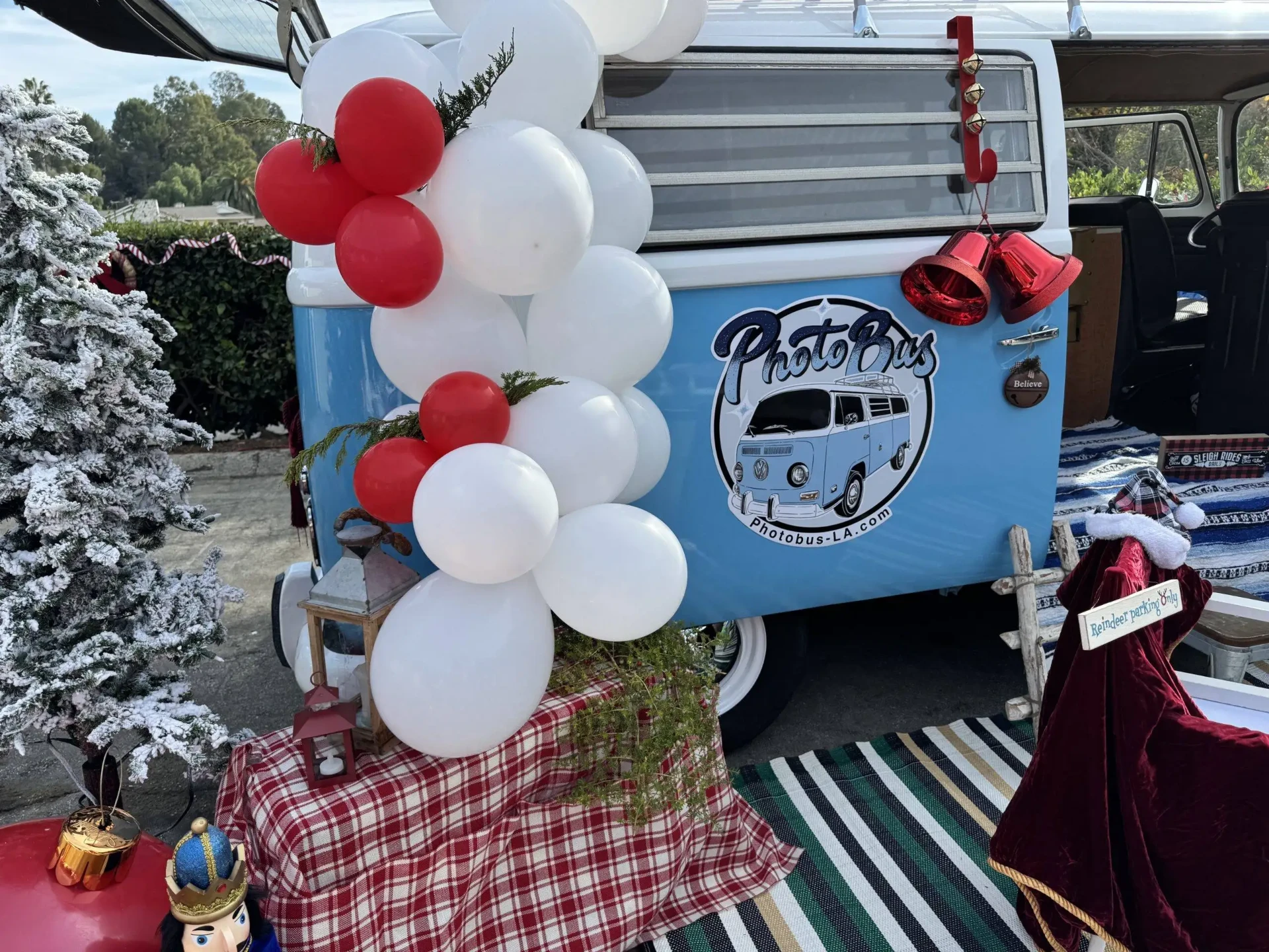 Hand-painted PhotoBus emblem styled with balloons at a brand activation